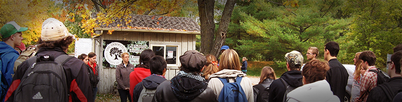 a group of students listen to their hike leader