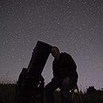 Trevor using equipment to view night sky