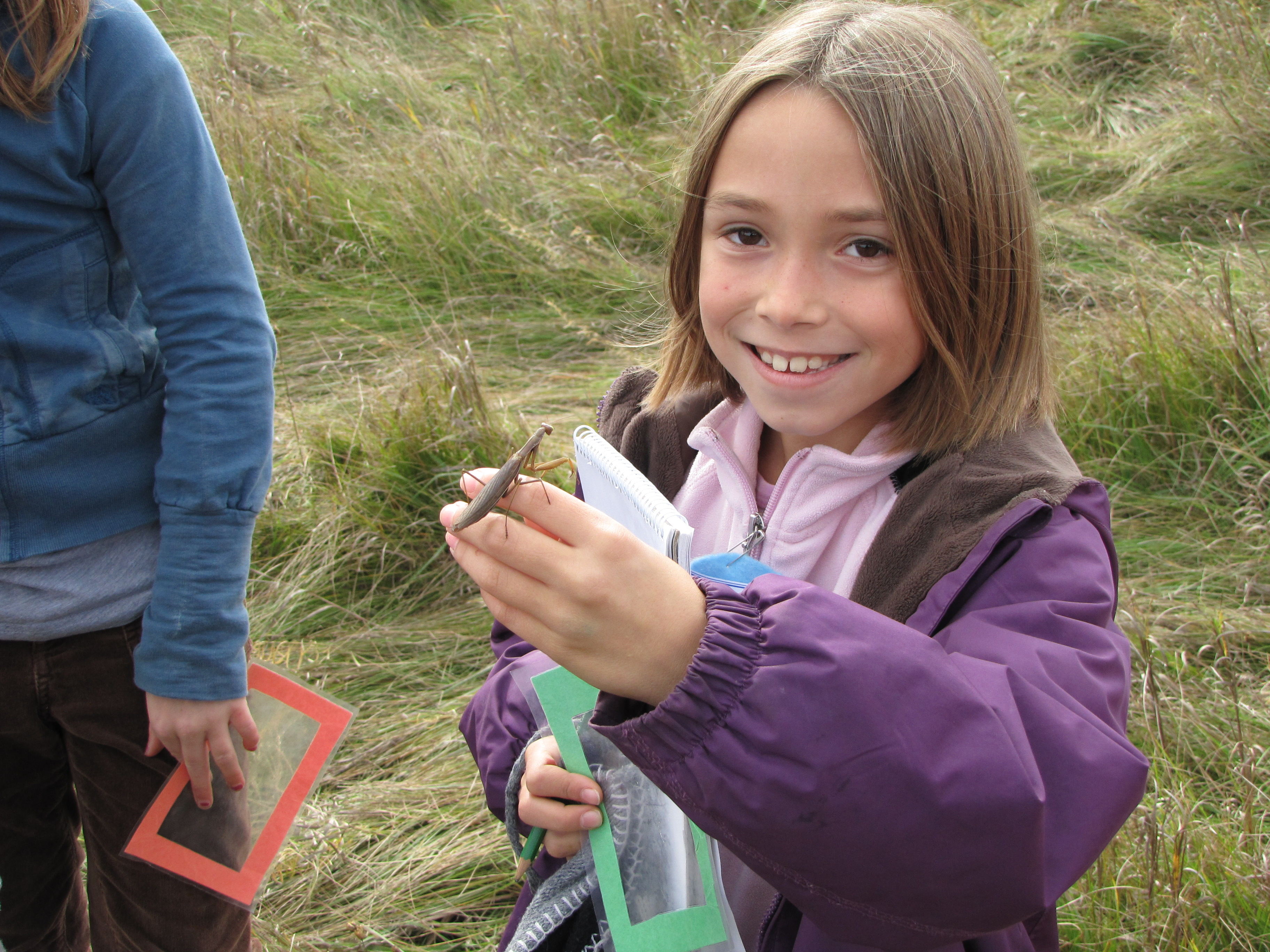 Girl Holding a Praying Mantis near the J.C. Taylor Nature Centre